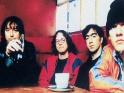 R.E.M., zleva Peter Buck, Mike Mills, Bill Berry, Michael Stipe, cca pol. 90. let